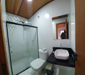 a bathroom with a toilet and a sink and a shower at Pousada Mirai -Centro- in Arraial do Cabo +15 photos