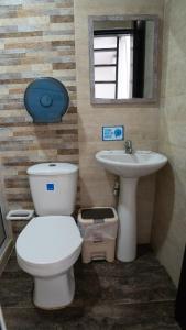 a bathroom with a toilet and a sink and a mirror at Rocky Cay Lodging in San Andrés