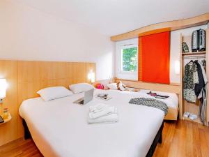 Postel nebo postele na pokoji v ubytování ibis Mulhouse Centre Filature