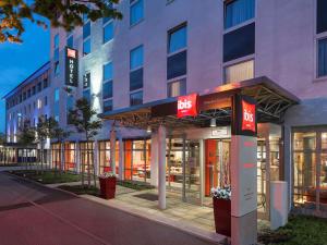 a facade of a building with a hotel at ibis Hotel München Garching in Garching bei München