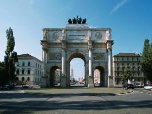 a building with an arch in the middle of a street at ibis Hotel München Garching in Garching bei München