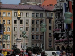 a group of people walking around a street with buildings at ibis Hotel München Garching in Garching bei München