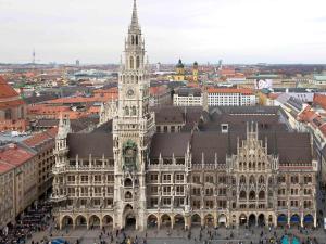 a large building with a clock tower in a city at ibis Hotel München Garching in Garching bei München