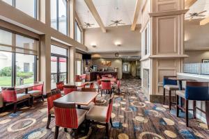 a restaurant with tables and chairs and windows at Comfort Inn & Suites Warsaw near US-30 in Warsaw