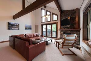 a living room with a couch and a fireplace at Ishi Couloir in Niseko