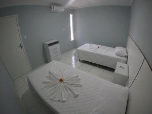 Ένα ή περισσότερα κρεβάτια σε δωμάτιο στο Flats Recanto do Sol