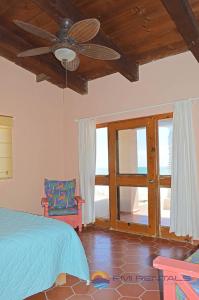 a bedroom with a bed and a ceiling fan at Casa Chapman by FMI Rentals in Puerto Peñasco