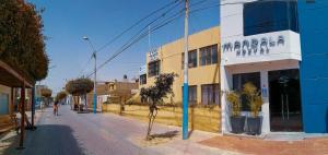 a building on the side of a street at Mandala in Pisco