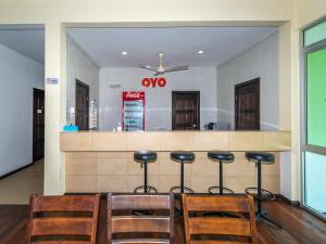 a restaurant with a bar with chairs and a counter at OYO 90036 Eagle Wood Garden in Membakut