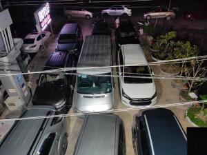 a group of cars parked in a parking lot at Hoàng Sa Hotel in Xóm Nhà Mát