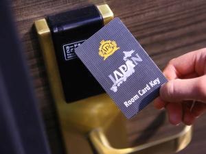 a person holding a purple tag on a camera at APA Hotel Shin Osaka Minamikata Ekimae in Osaka