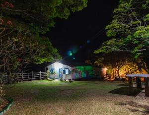 a building with graffiti on it at night at Sítio Lavras do Abade in Pirenópolis