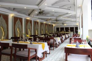 a dining room with tables and chairs in a restaurant at Khmer Mansion Residence in Siem Reap