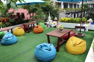 a patio with tables and bean bags on the grass at Khmer Mansion Residence in Siem Reap