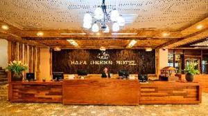 a lobby of a hotel with a person sitting at a counter at Sapa Green Hotel in Sapa