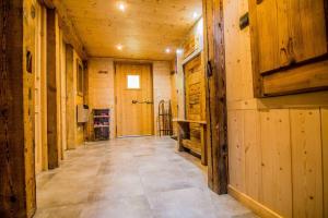 a hallway in a log cabin with wooden walls at Beautiful, atypical loft in the Aravis in Les Clefs