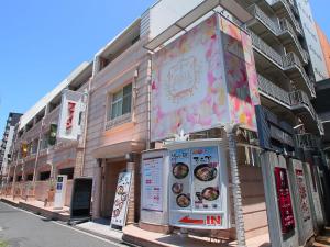 a building with a sign on the side of it at Hotel Fine Garden Umeda in Osaka