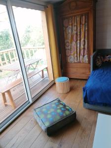 a bedroom with a bed and a large sliding glass door at Tipergwendiou in Plougonvelin