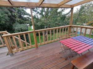 a wooden deck with a picnic table on it at Tipergwendiou in Plougonvelin