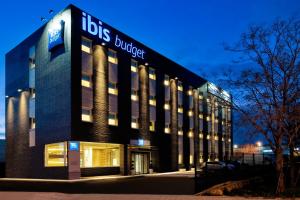 a large building with a sign on the side of it at Ibis Budget Madrid Getafe in Getafe