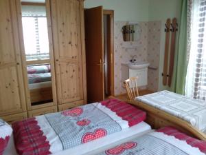 a bedroom with two twin beds and a sink at Appartement Hinterleiten in Wagrain +12 photos