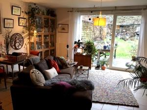 a living room with a couch and a large window at Chambre privée in Épinal