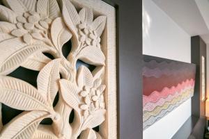 a wooden panel with a painting on a wall at Hotel Seagull Tenpozan Osaka in Osaka