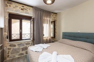 A bed or beds in a room at Carya Residence