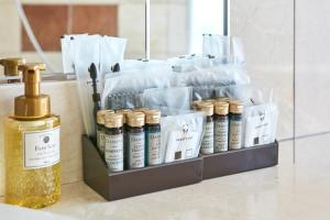 a shelf with a bottle of essential oils on a counter at Hotel Seagull Tenpozan Osaka in Osaka
