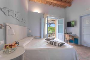 Postel nebo postele na pokoji v ubytování Aquae Sinis Albergo Diffuso + 37 fotografií