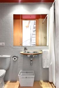 a bathroom with a sink and a toilet and a mirror at SA CASETA Sant Antoni 3 casa con encanto in Cadaqués +16 photos