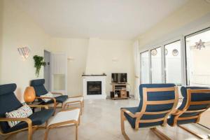a living room with chairs and a fireplace at Seaview and sun all day long in Los Pinos, Almuñecar, Andalusia in Almuñécar