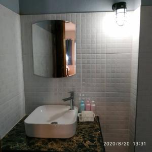 a bathroom with a sink and a mirror at เรือนวรา - Wara Guesthouse in Nan +13 photos