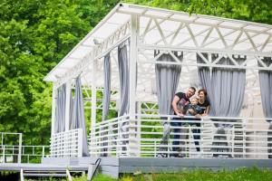 a family standing in front of a white tent at Vozdvizhenskoe Park Hotel in Serpukhov