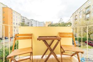 2 sedie in legno e una scrivania sul balcone di Scandinavian Gdynia a Gdynia