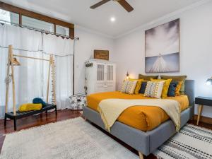 a bedroom with a king sized bed with orange sheets at Black Beauty Studio in Bangalow