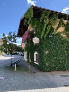 a building covered in ivy with a sign on it at Haus Lukas in Hopfgarten im Brixental