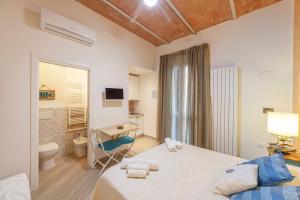 a bedroom with a bed and a bathroom with a toilet at B&B Prima Dell'Elba in Piombino