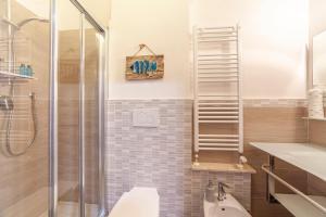 a bathroom with a shower and a toilet and a sink at B&B Prima Dell'Elba in Piombino