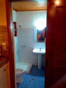 a bathroom with a sink and a toilet at Sunrise Apartments in Palekastron