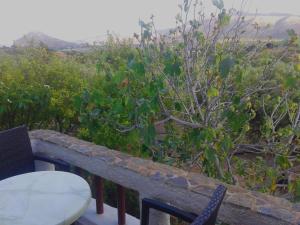 a table and chairs on a balcony with a view at Sunrise Apartments in Palekastron