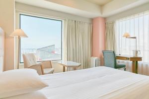 a hotel room with a bed and a desk at Hotel Seagull Tenpozan Osaka in Osaka