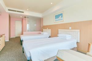 a hospital room with two beds and a sink at Hotel Seagull Tenpozan Osaka in Osaka