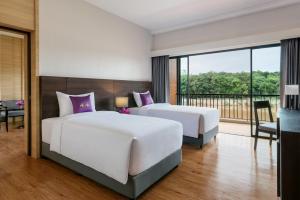 Chainarai Riverside - SHA Plus Certified客房内的一张或多张床位