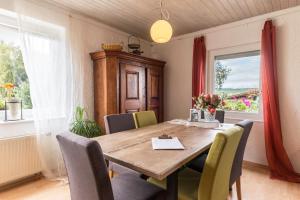 a dining room with a wooden table and chairs at Appartement Böhler 1 in Reichenau