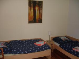 a room with two beds and a painting on the wall at Ferienwohnung am Spitzberg in Suhl