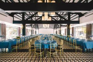 a long banquet hall with blue tables and chairs at Seava Ho Tram Beach Resort in Ho Coc