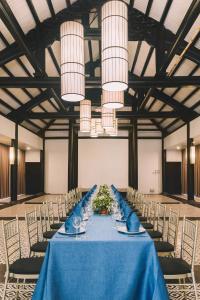a long table with a blue table cloth and chairs at Seava Ho Tram Beach Resort in Ho Coc