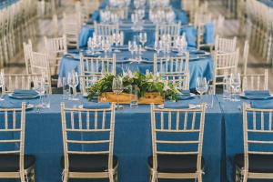 a blue table set up for a wedding with chairs at Seava Ho Tram Beach Resort in Ho Coc