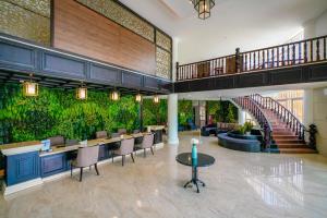 a lobby with a large wall of plants at Seava Ho Tram Beach Resort in Ho Coc